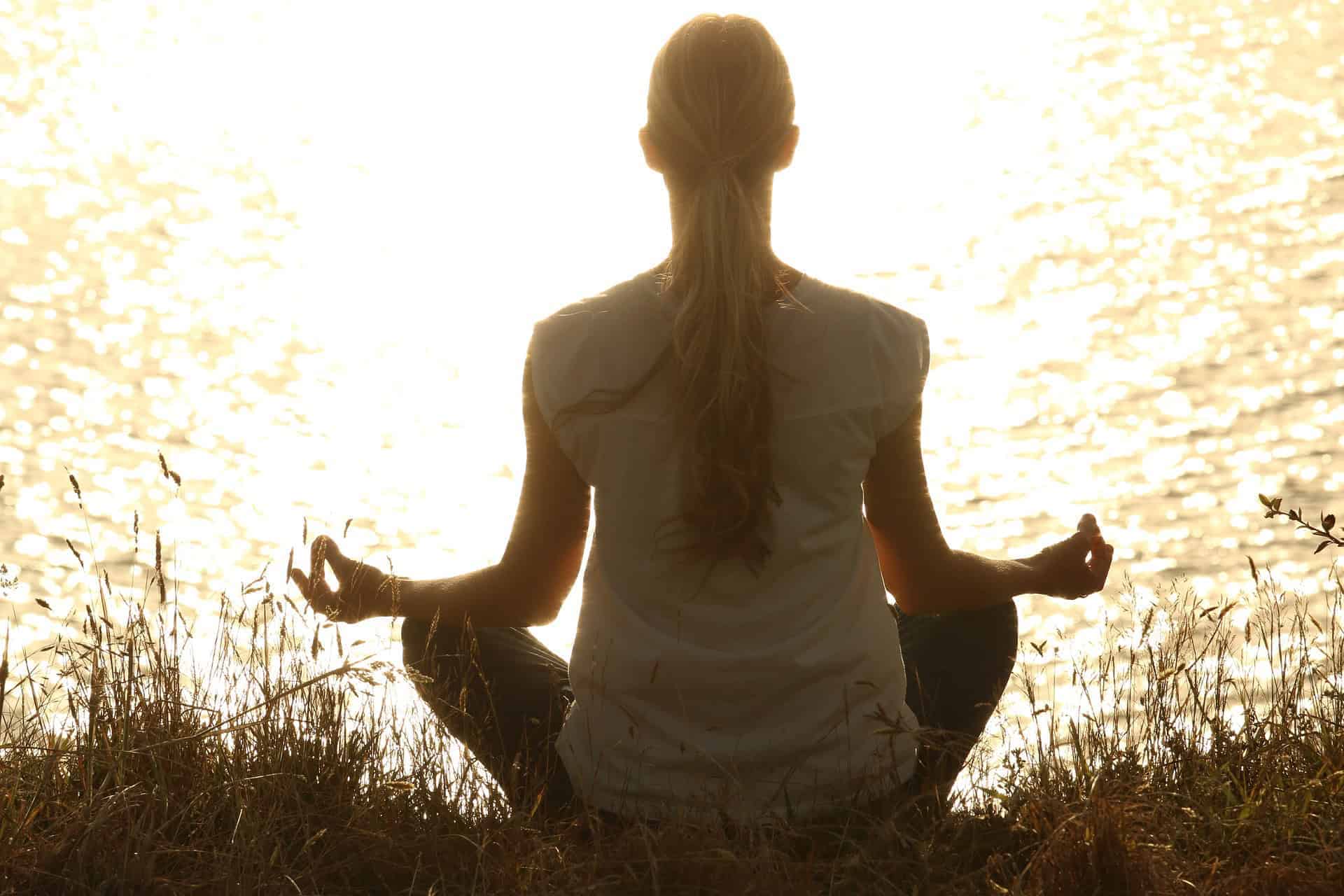 fasting meditation over lake sunrise long hair